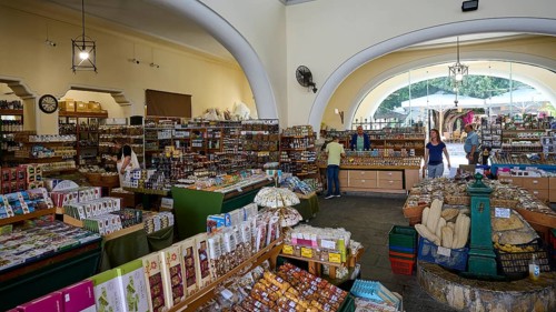 Interior view of a market with abundant produce and large arched windows, Market Hall, Agora, Kos