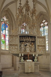 High altar of the Romanesque St. Mary's Church, interior view, colourful stained glass windows,