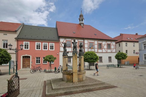 Baroque town hall built in 1699 and fountain with sculptures by Christof Traub 1995, symbols for