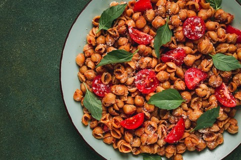 Tuscan pasta with smoked paprika and basil, parmesan cheese, Italian traditional cuisine