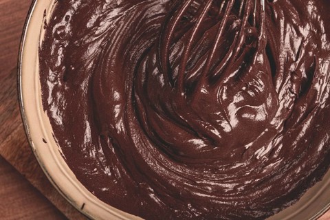 A bowl of chocolate dough, a whisk for whipping, baking, structure and consistency, homemade, top