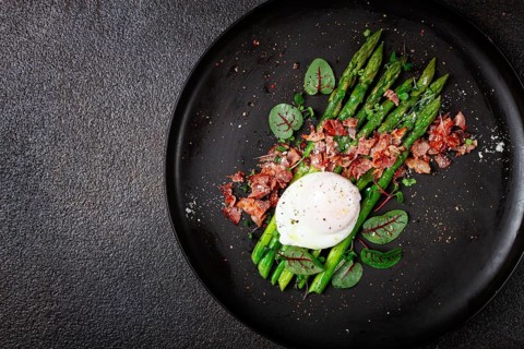 Asparagus with poached egg and fried bacon, micro greens and spices, breakfast, homemade, no people