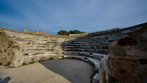 ©Udo Rein, Stone amphitheatre with rows of seats and open area, surrounded by ancient masonry,