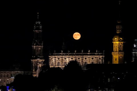 Glowing strawberry moon on 11 June 2025 over the Hofkirche Dresden, Saxony, Germany