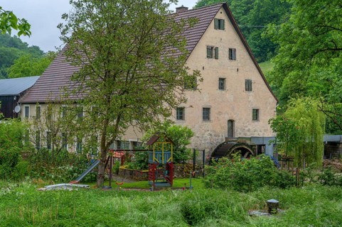 Former corn mill with water wheel, Großenohe, Upper Franconia, Bavaria, Germany