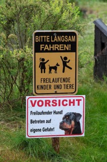 Warning signs in front of a farm, Bavaria, Germany