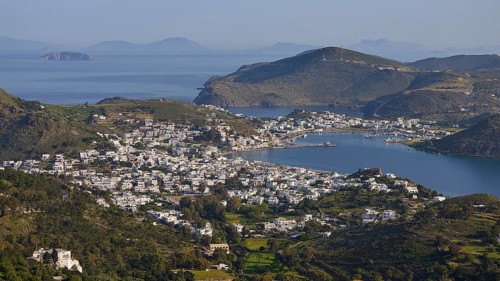 Far-reaching panorama of a town between hills and sea, islands in the distance, Skala, harbour,