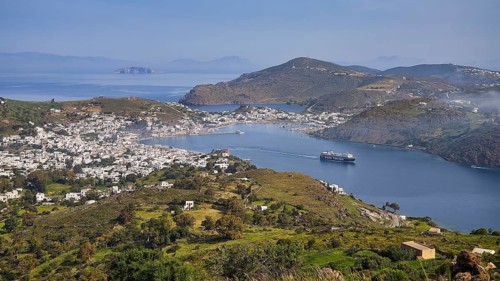 Panoramic view of a bay with town, ferry and surrounding landscape, Skala, harbour, Patmos,