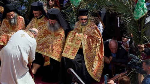 Priests in golden robes perform a religious ritual in front of a gathered crowd, Orthodox ceremony,