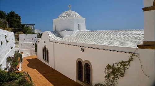 Cross-domed church Panagia Diasosousan, white church in Mediterranean style with dome and cross,