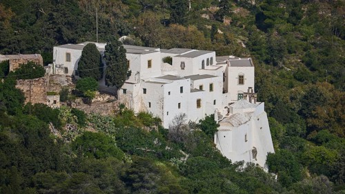 Monastery on a green hill with trees and surrounding nature, Monastery of the Revelation, Moni tis