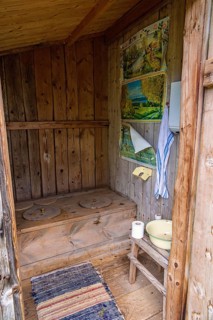 Interior of an old idyllic wooden outhouse for two in the swedish countryside, Sweden