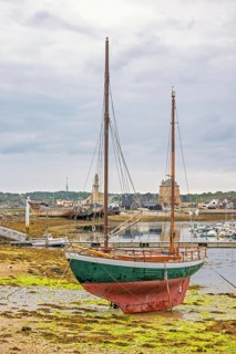Old wooden sailboat on the beach in a harbour at low tide, Camaret-sur-Mer, Crozon peninsula,