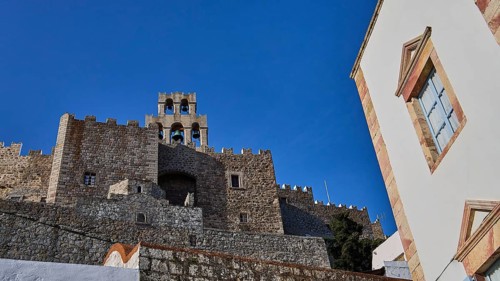 Stony old castle with walls and towers under a blue sky, Monastery of St John the Theologian,