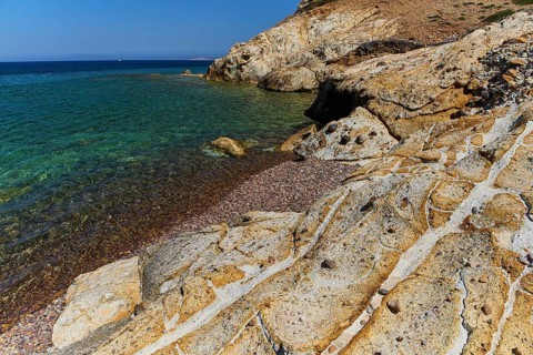 Rugged coastline with clear blue waters and sunlit rocks, Lambi Beach, Lambi Bay, Patmos,