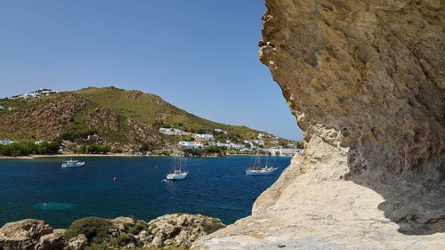 Several sailing boats on the sea, framed by rocks and white coastal town, Grikos, Petra, Chora,