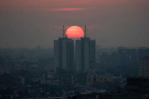 Sunset over skyscrapers in Buenos Aires, symmetry in photography, symbolic image for heat, global