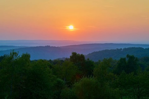 Sunset with red tones over hills and trees, quiet evening landscape, Geishöhe, Dammbach, Spessart,