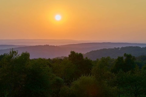 Sunset over wooded hills with orange-coloured sky, peaceful evening mood, Geishöhe, Dammbach,