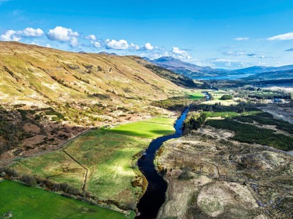 Farms and Mountains over River Dochart and Road A85 from a drone, Perthshire, Scotland, UK