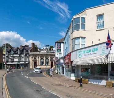 Shops in street of historic buildings, Piermont Place, Dawlish, south Devon, England, UK