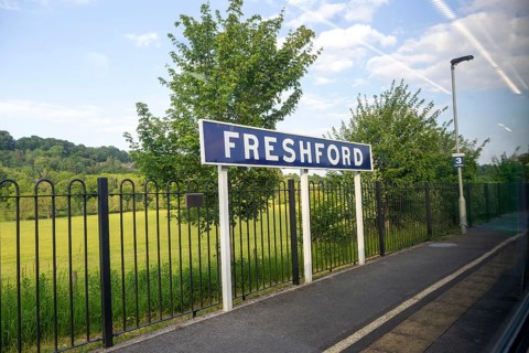Freshford railway station platform sign taken through train window, Somerset, England, UK