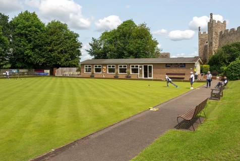 People playing lawn bowls at Framingham Castle bowling club, Suffolk, England, UK