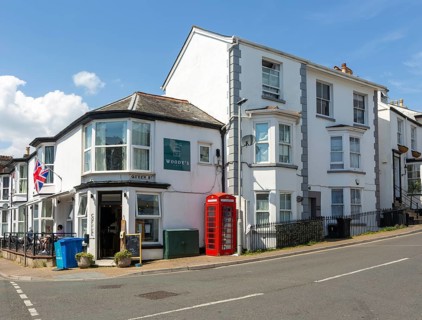 Historic buildings old red telephone box, Woody's cafe, Queen Street, Dawlish, south Devon,
