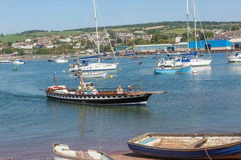 Shaldon ferry arriving, small boats in harbour at Back Beach, Teignmouth, south Devon, England, UK