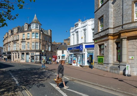 Street and shops including WH Smith in town centre of Teignmouth, south Devon, England, UK