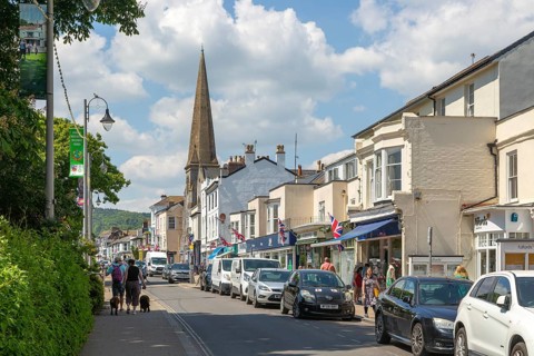 Shops in street of historic buildings, The Strand, Dawlish, south Devon, England, UK