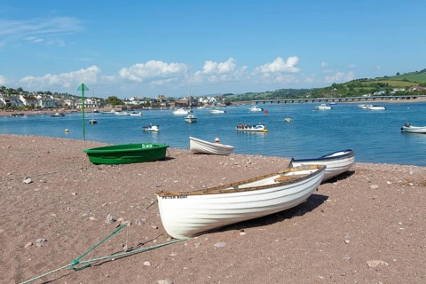 Small boats in harbour at Back Beach, Teignmouth, south Devon, England, UK view to Shaldon bridge