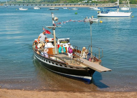 Shaldon ferry arriving, small boats in harbour at Back Beach, Teignmouth, south Devon, England, UK
