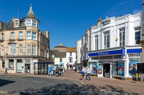 Street and shops including WH Smith in town centre of Teignmouth, south Devon, England, UK