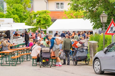 Lively street festival with many people at beer tent sets, cheerful and sociable atmosphere, family