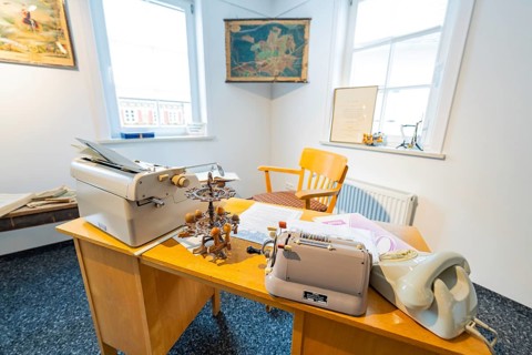 Old-fashioned office with typewriter, desk and chair, lit by daylight, family party in Neubulach,