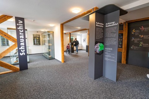 Interior of a mineral museum with information panels on radioactive materials, family festival in