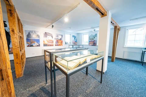 Modern room with photographs and glass showcases, stylish presentation, family celebration in