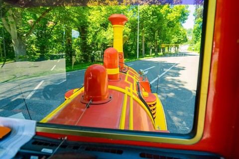 View from a train on a green forest road in sunny weather, Calw railway station festival, Black