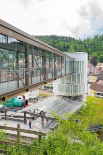 Modern bridge and tower in an urban landscape with hills in the background, Zob extension with