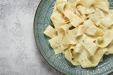 Pasta papardelle in creamy garlic sauce, traditional Italian cuisine, pasta carbonara, homemade, no