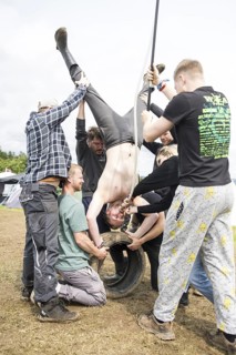 Festival visitors drinking from a funnel on a campsite at the Rock am Ring Festival on Saturday,