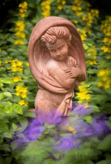 Terracotta statue, girl, between spotted loosestrife (Lysimachia punctata), also spotted