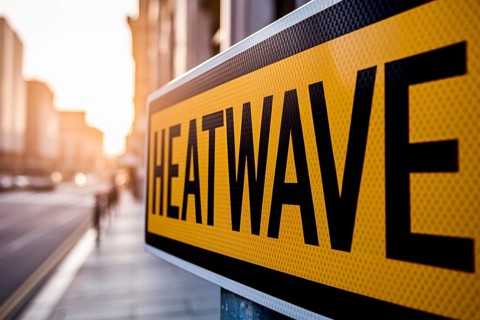 Yellow heatwave warning sign in hot weather conditions n city. Generative ai, AI generated