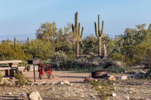 Camping chairs at a desert campsite at the White Tank Mountain Regional Park campground in Phoenix,