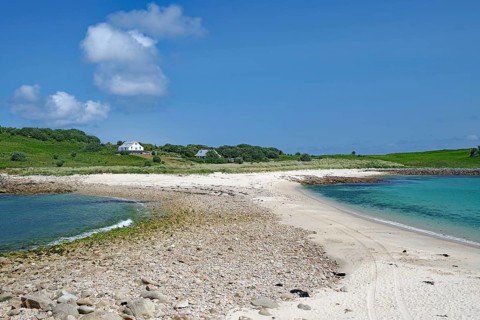 Expansive sandy landscape with views of tranquil bays and green hills, St Agnes, Isles of Scilly,