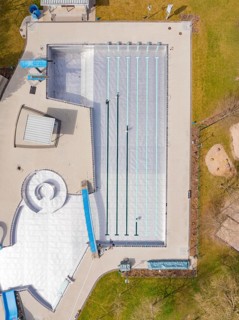 Aerial view of the swimming area with large lawn and surrounding green park, renewal of the