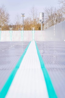 Empty swimming lane with focus on coloured lines and textured surface in the outdoor area, renewal
