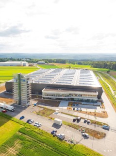 Modern factory complex with large-scale roof construction in a green landscape, ING Park