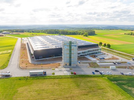 Spacious landscape with a large industrial building and fields, ING Park development area,